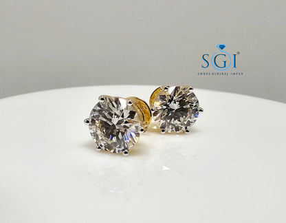 Diamond stud earrings on a white surface with SGI logo.