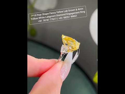 7*10 mm (2.10ct) pear shape fancy yellow and 4mm (0.60ct) White F VVS1 Labgrown diamond Engagement Ring with 14k white gold